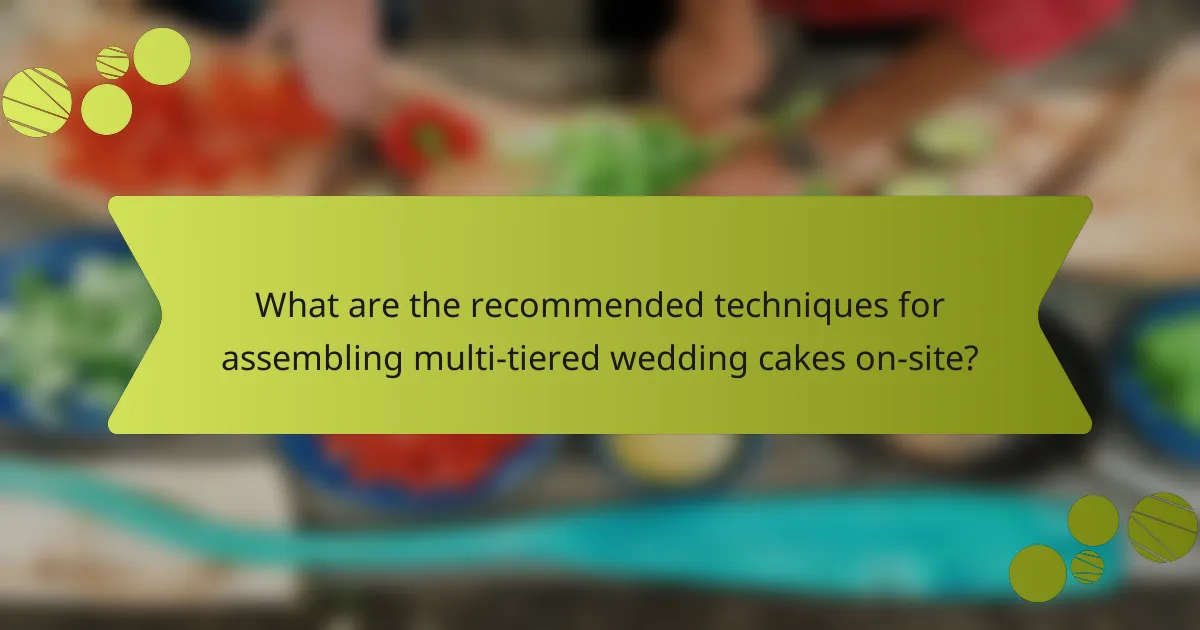 What are the recommended techniques for assembling multi-tiered wedding cakes on-site?